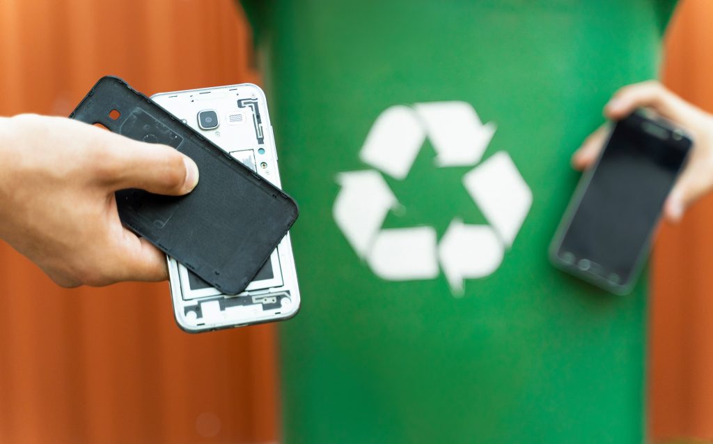 Person recycling a phone.